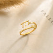 Load image into Gallery viewer, 777 Angel number Silver ring placed on top of a piece of paper