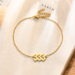 Load image into Gallery viewer, Angel number 333 gold anklet placed on top of a book333 Angel number gold anklet placed on top of a piece of paper