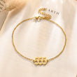 Load image into Gallery viewer, 555 Angel number gold anklet placed on top of a piece of paper