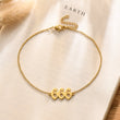 Load image into Gallery viewer, Angel number 666 gold anklet placed on top of a book