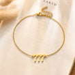 Load image into Gallery viewer, 777 Angel number gold anklet placed on top of a piece of paper