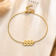Load image into Gallery viewer, 888 Angel number gold anklet placed on top of a piece of paper