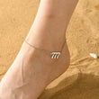 Load image into Gallery viewer, A model wearing a 777 Angel Number Silver-plated Anklet