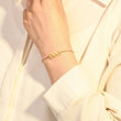 Load image into Gallery viewer, A model wearing an Angel Number 999 bracelet on her wrist