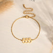 Load image into Gallery viewer, Angel Number 555 gold bracelet on a canvas background