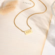Load image into Gallery viewer, 888 angel number pendant gold necklace laid out
