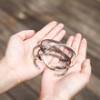 Load image into Gallery viewer, A model holding Not Sisters By Blood But Sisters By Heart Bracelets